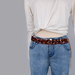 Leopard print acrylic link waist chain with gold metal adjustment on denim jeans