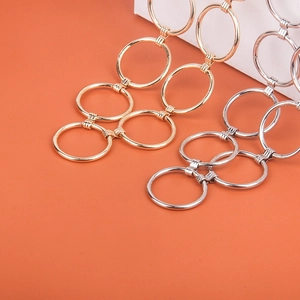 Detailed close-up of metallic gold and silver circular link chain belts for dresses