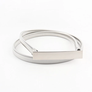 Close-up of a silver elastic spring belt featuring a minimalist rectangular metal buckle