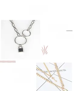 Detail of lock and key pendants on polished gold and silver tone chain belts