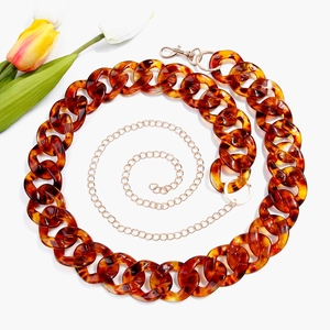 Detail of leopard print acrylic chain belt with golden metal link and lobster clasp