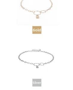 Detail view of gold and silver padlock pendant chains with metallic geometric link structure