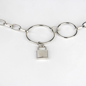 Detail of silver chain belt with lock pendant and geometric metal ring buckle
