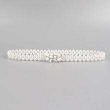 Detail of elastic pearl waist chain with rhinestone flower clasp and triple-row beads