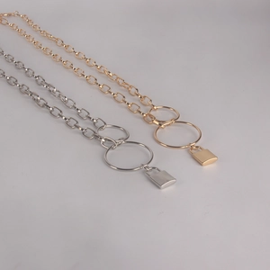 Industrial style chunky chain waist belt with lock pendant in gold and silver finish