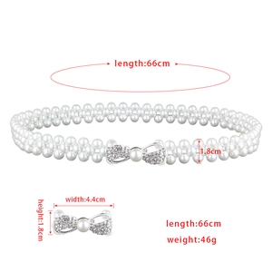 Detail view of elastic pearl waist belt showing three-row design and rhinestone bow buckle