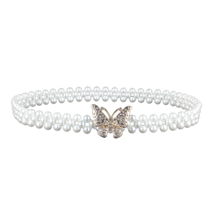 Detailed view of women's elastic pearl belt featuring a rhinestone-studded butterfly buckle