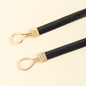 Minimalist black patent leather waist belt for women with sleek gold metal buckle