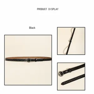 Détail d'une ceinture en cuir noir avec perforations circulaires et boucle en métal