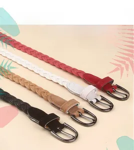 Close-up of four thin braided waist belts in red, white, camel and black with metal buckles