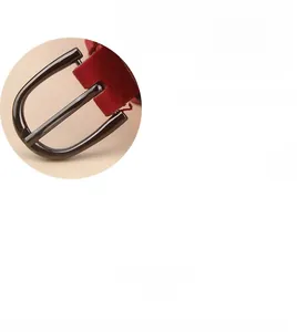 Close-up of sleek D-shaped metal buckle and red suede texture on a slim waist belt