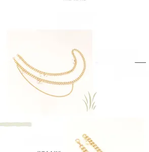 Detail view of multi-layer gold chain accessory with white pearls and lobster clasp