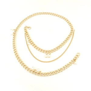 Detail of multilayer gold alloy waist chain featuring elegant white pearl accents and lobster clasp