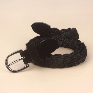 Close-up of black braided women's belt with gunmetal pin buckle and suede leather details