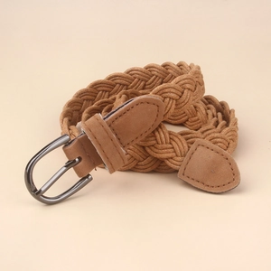 Detail view of a woven vintage style camel brown belt with a metallic pin buckle