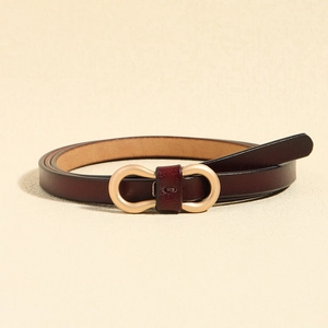 Detailed close-up of dark red leather thin belt with golden infinity buckle