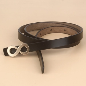 Detail of black leather belt with golden infinity buckle and smooth brown lining