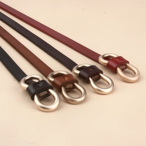 Detail view of thin leather waist belts in four colors with gold infinity figure-8 buckles