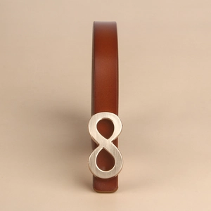 Detailed close-up of brown leather belt with infinity symbol silver metal buckle