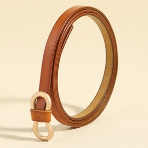 Detailed view of the slim brown leather belt with a matte champagne gold infinity buckle
