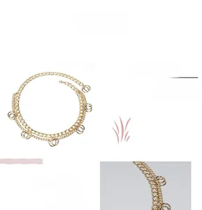 Detail of multi-layer gold geometric body chain featuring handmade solid polished metal rings