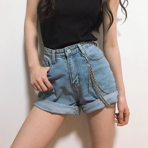 Detail of silver triple-layered chain tassel on light blue denim shorts for street style