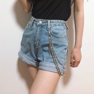Detail of light blue denim shorts with layered silver metal chains and rolled hem edges