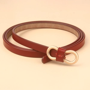 Detailed close-up of dark red leather skinny belt with figure-eight gold metal buckle