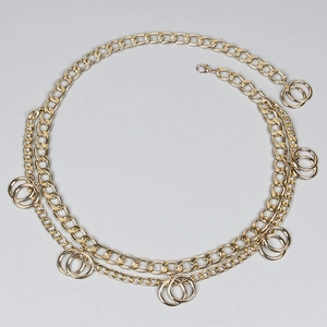Detail of a multi-layer golden aluminum waist chain with circular charms and lobster clasp
