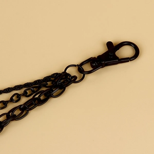 Detail shot of multi-layered black metal trousers chain with lobster clasp for street fashion