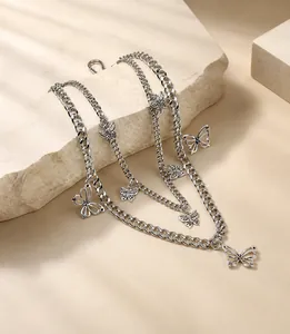 Detail view of silver multi-layered waist chain with polished butterfly pendants