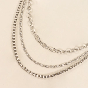 Three styles of silver hip hop metal pants chains with star charms on leather background