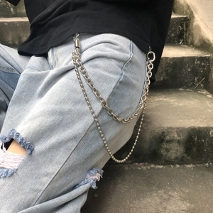 Close-up of hip-hop style silver double-layer metal pant chain on light blue denim jeans