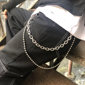 Close-up of dual-layer punk style silver metal pants chain with beads and link chain detail