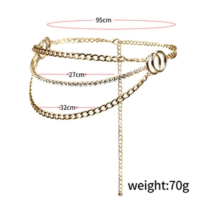 Detail view of golden multi-layer waist chain featuring rhinestones and Cuban link style