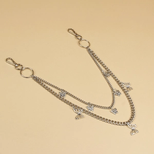 Macro detail of silver layered butterfly chain with sturdy lobster clasps for trousers