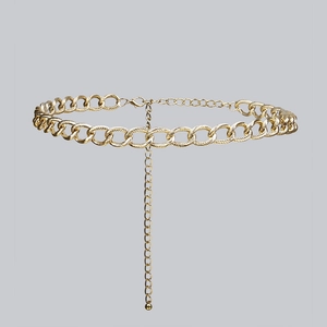 Detail of gold metal waist chain featuring textured oval links and lobster clasp closure