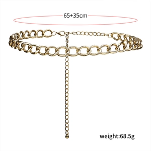 Detail of gold metal waist chain featuring textured oval links and lobster clasp closure