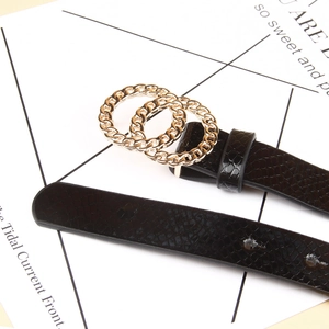 Detailed macro view of the black snake-patterned leather belt with a golden double-O ring buckle