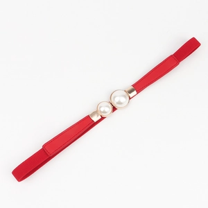 Detail of red elastic waist belt with elegant dual pearl gold buckle for dresses
