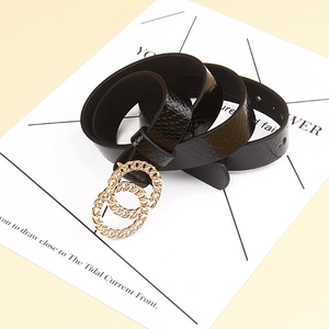 Close-up of black snake embossed belt featuring a stylish gold double ring metal buckle