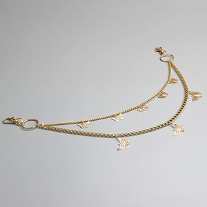 Detail of golden double-layer chain with hollow butterfly charms and lobster clasps