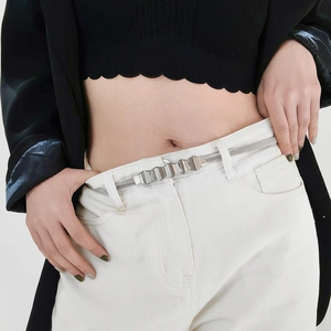 Close-up of a silver geometric wave buckle on a metallic chain belt for summer dresses