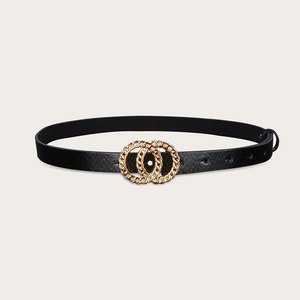Detail of black snake-embossed leather belt with decorative interlocking gold rings buckle