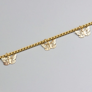Close-up of golden double-layer chain with delicate hollow butterfly pendants and link detail