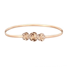 Detail of rose gold spring waist chain featuring three three-dimensional carved roses