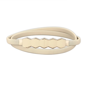 Detail of beige elastic woven belt featuring gold hexagonal geometric metal buckle