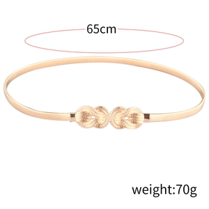 Detail view of gold spring belt for women with 65cm length and twisted knot buckle