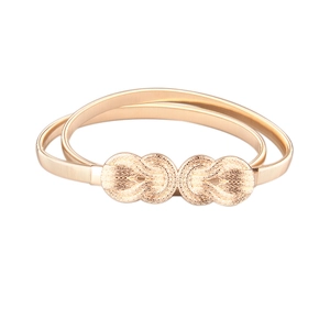 Detailed close-up of golden elastic metal waist chain with elegant interlaced mesh texture