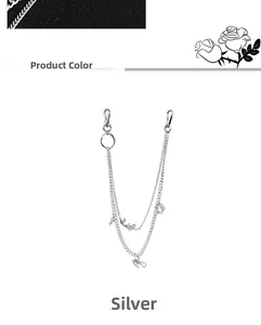 Close-up of silver multilayer pants chain with dragon pendant and metal lobster clasps
